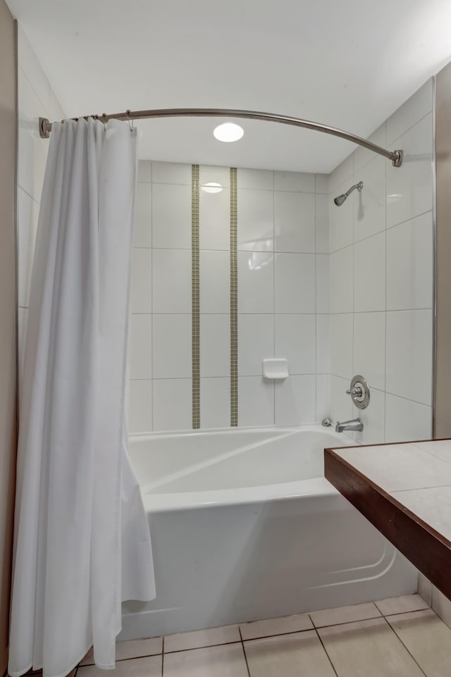 bathroom with tile patterned floors and shower / tub combo