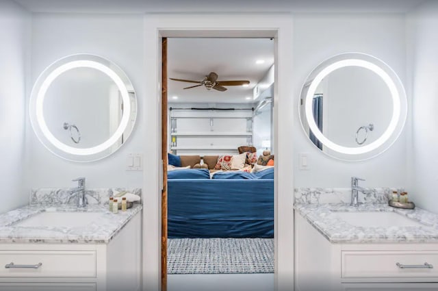 ensuite bathroom featuring a sink, two vanities, ensuite bath, and a ceiling fan