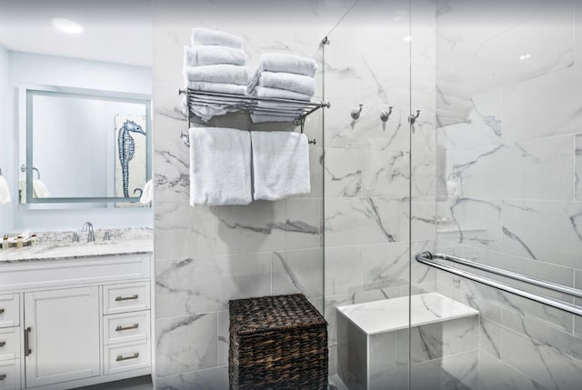 bathroom with a marble finish shower and vanity