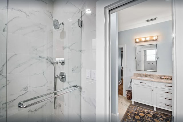 full bath with a marble finish shower, marble finish floor, visible vents, and vanity