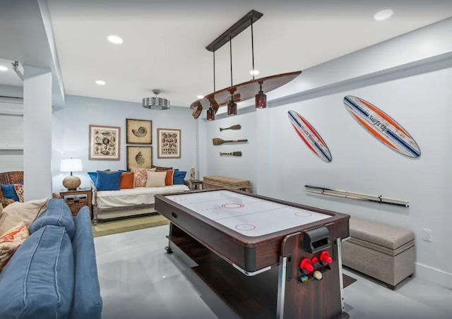 recreation room with finished concrete floors, recessed lighting, and baseboards