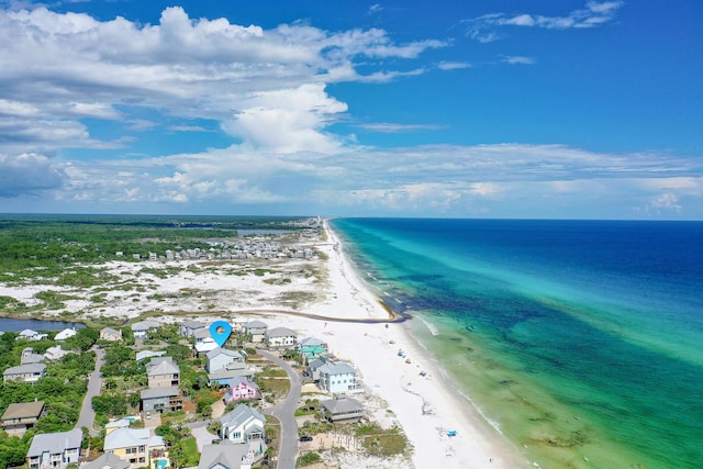 birds eye view of property with a water view and a view of the beach