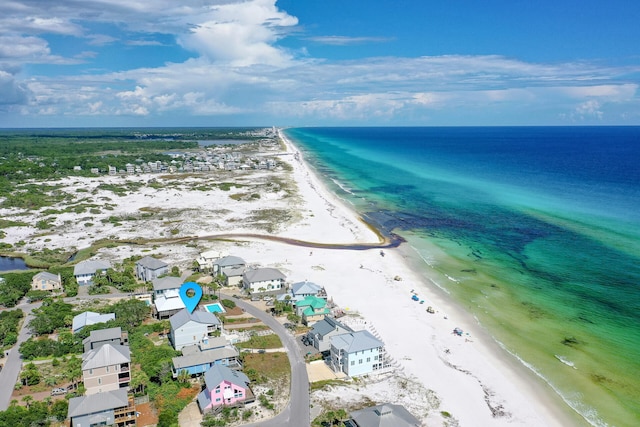 aerial view with a residential view, a water view, and a view of the beach