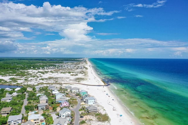 drone / aerial view with a residential view, a water view, and a view of the beach