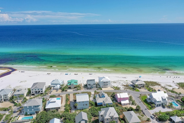 birds eye view of property featuring a residential view, a water view, and a beach view