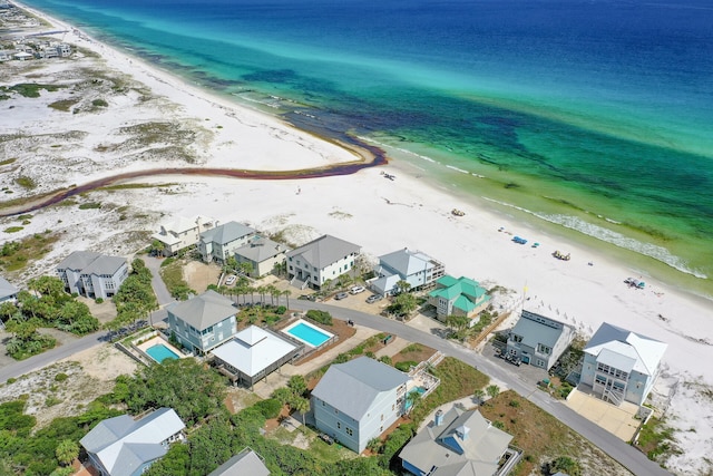 aerial view with a residential view, a water view, and a beach view