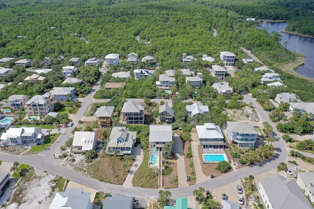 drone / aerial view featuring a view of trees and a water view