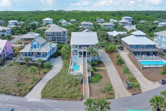 birds eye view of property with a view of trees