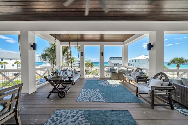 wooden terrace featuring outdoor lounge area and a water view