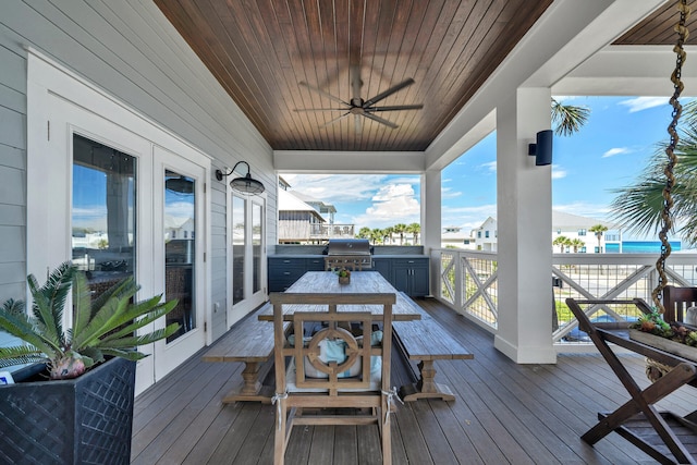 wooden terrace with a grill, outdoor dining space, and a ceiling fan