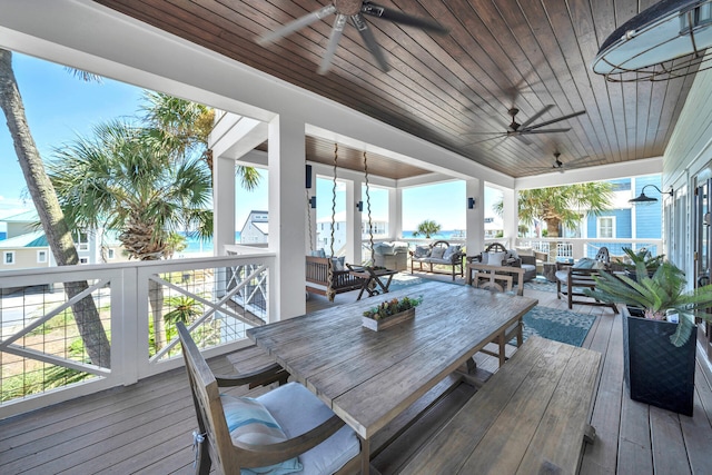 wooden terrace featuring outdoor lounge area and a ceiling fan