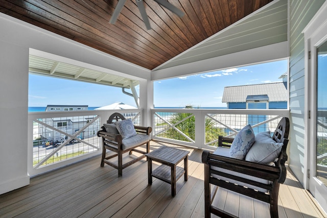 wooden terrace with an outdoor living space and a water view