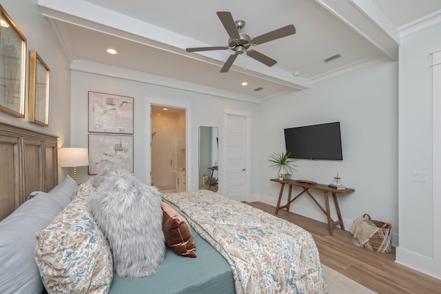 bedroom featuring crown molding, beamed ceiling, wood finished floors, and visible vents