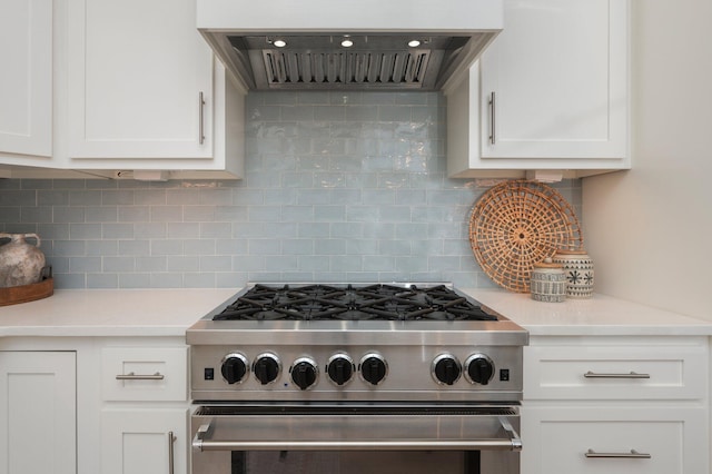 kitchen featuring white cabinetry, extractor fan, high end range, and light countertops