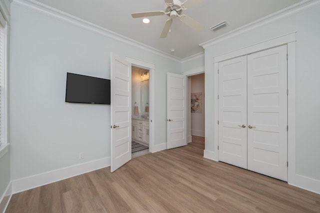 unfurnished bedroom with light wood-type flooring, visible vents, baseboards, and ornamental molding