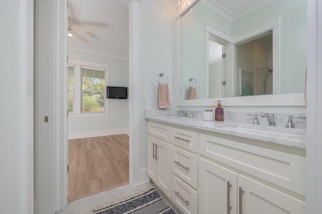 full bath with ceiling fan, crown molding, double vanity, and a sink