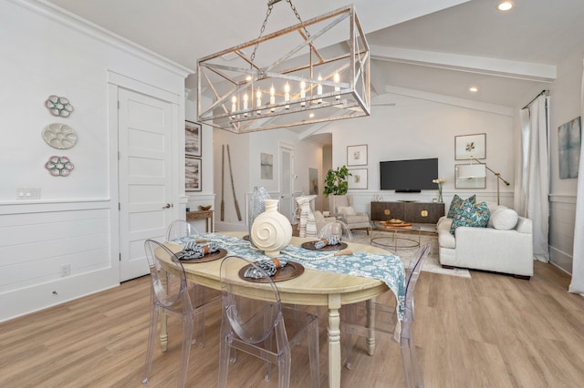 dining space featuring a notable chandelier, light wood-style flooring, lofted ceiling with beams, recessed lighting, and wainscoting