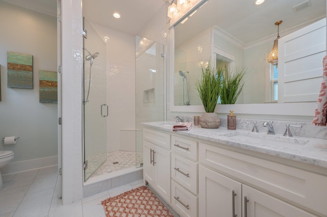 full bath with a sink, toilet, double vanity, and a shower stall