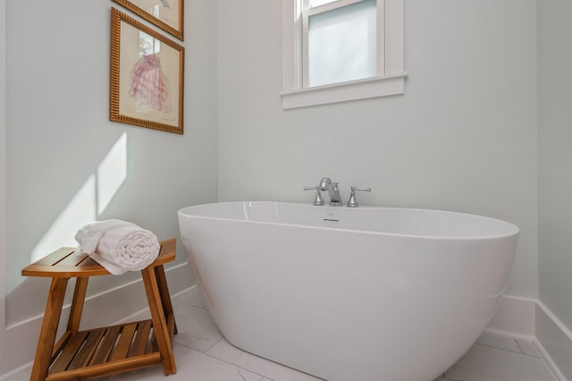 bathroom with baseboards and a soaking tub