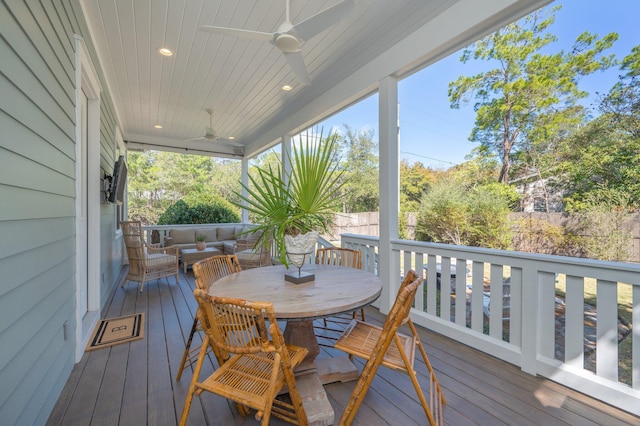 wooden deck with outdoor dining space, outdoor lounge area, ceiling fan, and fence