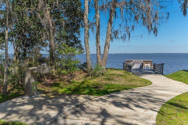 exterior space with a water view and a boat dock