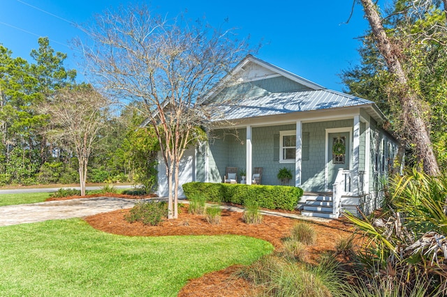 view of front facade featuring a porch, concrete driveway, a garage, and a front yard