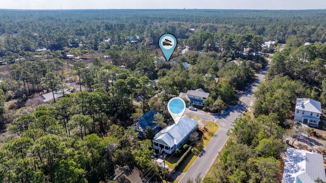 bird's eye view featuring a wooded view