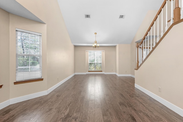 interior space featuring stairs, baseboards, visible vents, and dark wood-style flooring