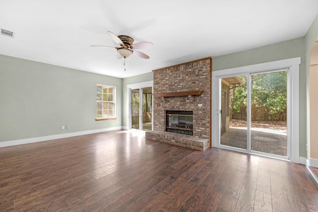 unfurnished living room featuring visible vents, baseboards, wood finished floors, and a ceiling fan