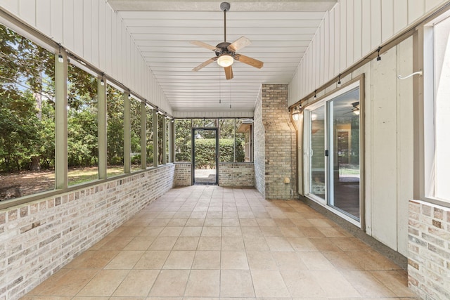 unfurnished sunroom with a ceiling fan