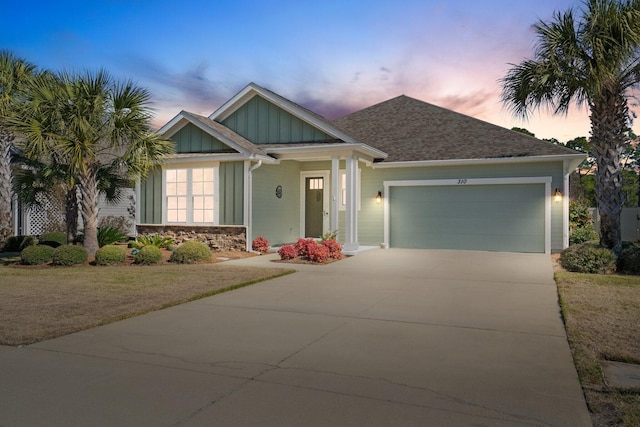 view of front of home with board and batten siding, concrete driveway, and an attached garage