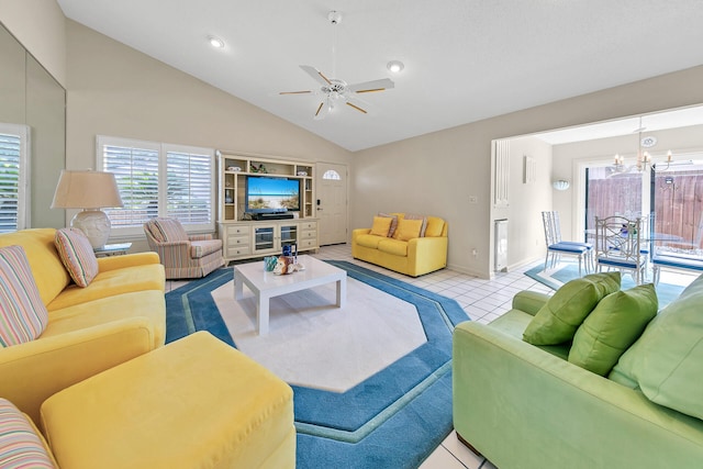 tiled living room with ceiling fan with notable chandelier, baseboards, and high vaulted ceiling