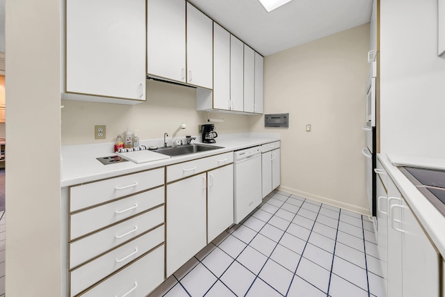 kitchen with a sink, white cabinetry, white dishwasher, light countertops, and light tile patterned floors