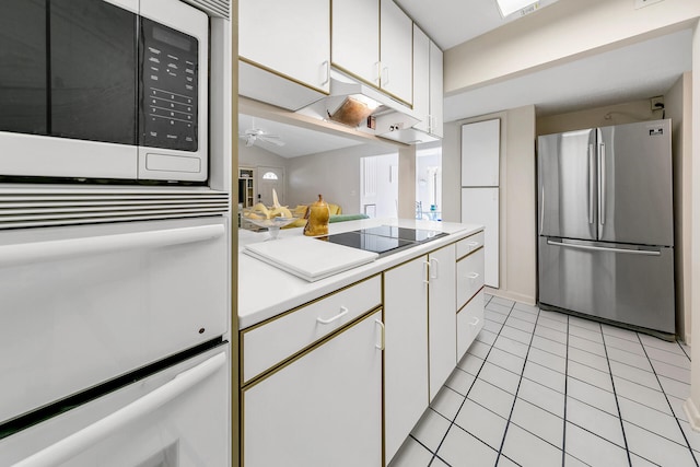 kitchen featuring white cabinetry, light countertops, light tile patterned floors, and stainless steel appliances