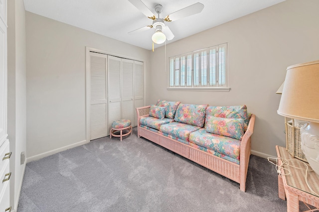 living area featuring ceiling fan, baseboards, and carpet