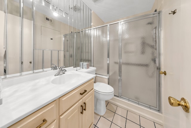 bathroom featuring visible vents, toilet, a shower with shower door, tile patterned floors, and vanity