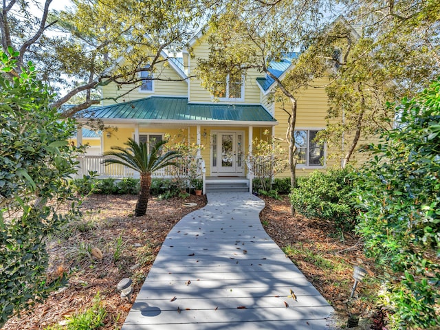 view of front facade featuring a porch and metal roof