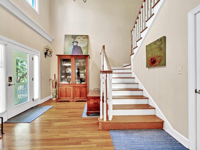 entrance foyer featuring stairway, plenty of natural light, and light wood-style floors