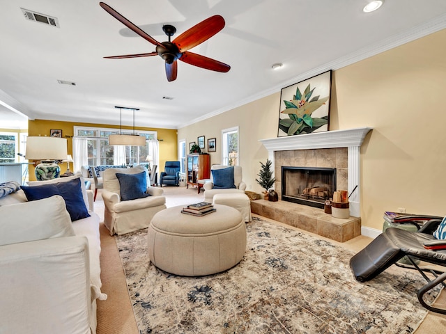 living area with carpet, visible vents, and ceiling fan