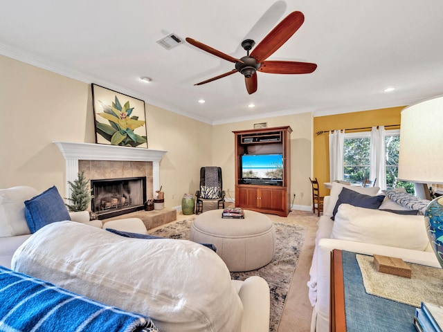 carpeted living room featuring a ceiling fan, baseboards, visible vents, ornamental molding, and a tiled fireplace