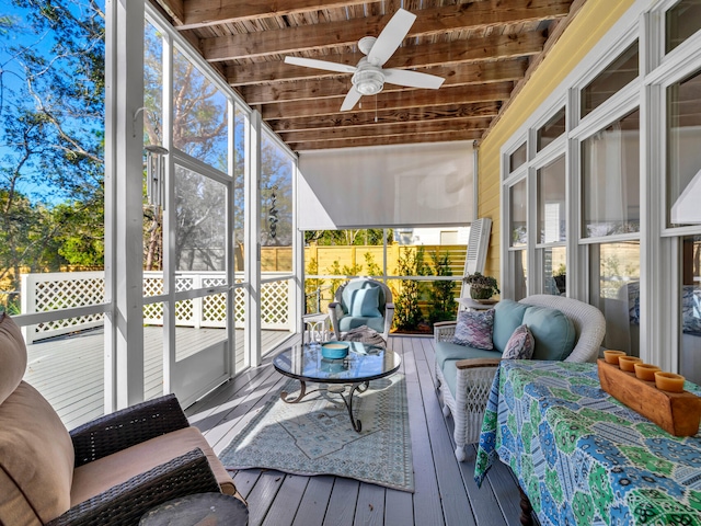 sunroom with beamed ceiling, wood ceiling, and ceiling fan