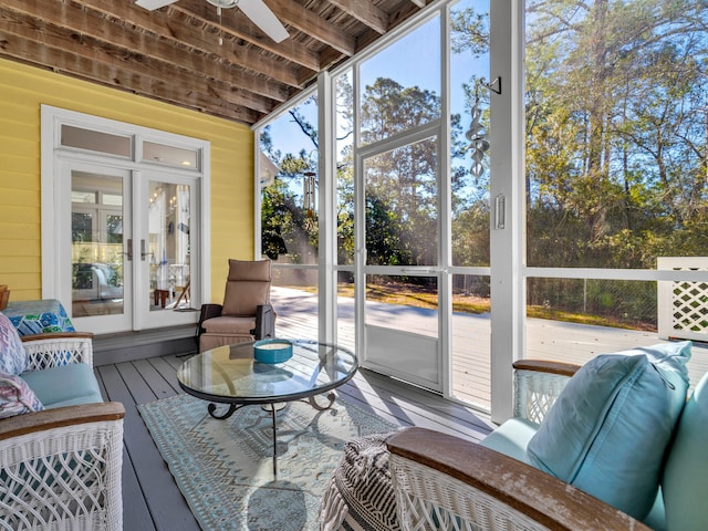 sunroom / solarium featuring a healthy amount of sunlight and a ceiling fan