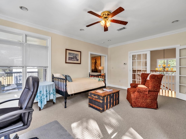 carpeted bedroom with visible vents, baseboards, ceiling fan, and crown molding