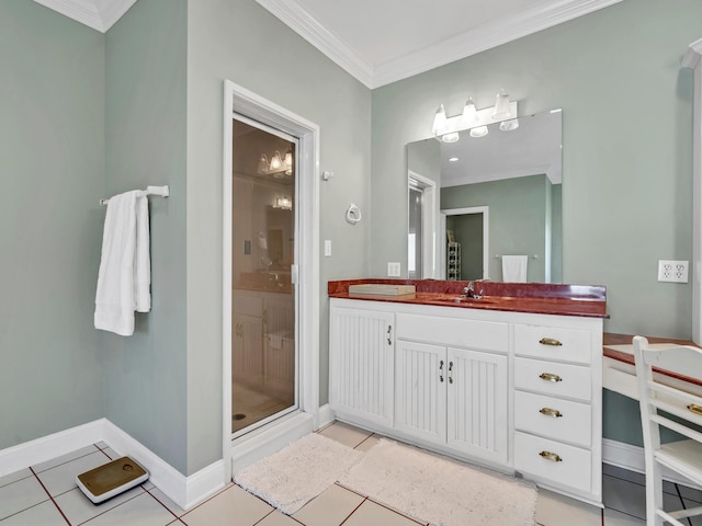 full bath with tile patterned floors, ornamental molding, a shower stall, baseboards, and vanity