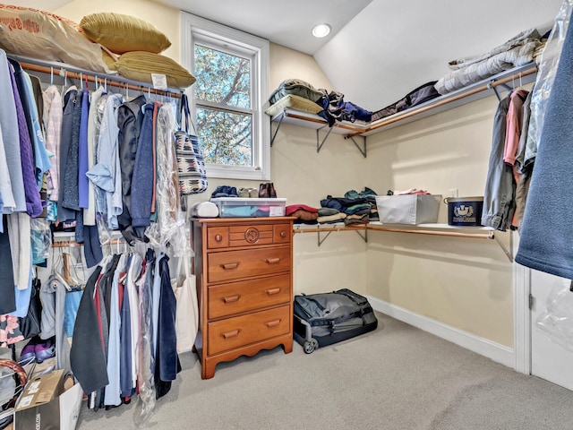 walk in closet featuring vaulted ceiling and carpet floors