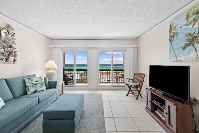 living room with a textured ceiling, light tile patterned floors, and ornamental molding