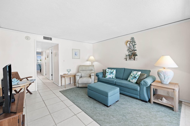 living room featuring light tile patterned floors and visible vents