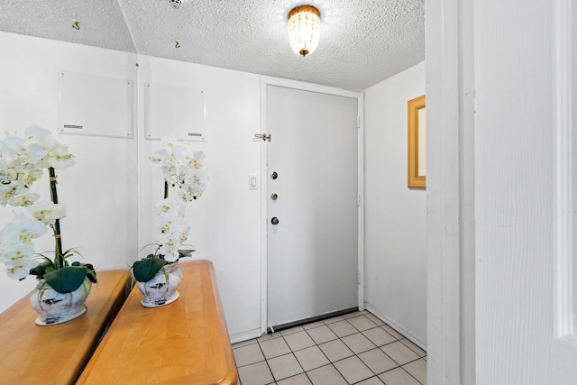 entrance foyer featuring light tile patterned flooring and a textured ceiling