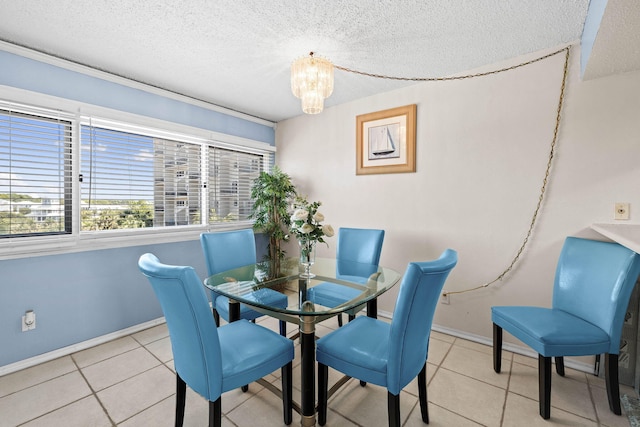 tiled dining area featuring a textured ceiling, baseboards, and a chandelier