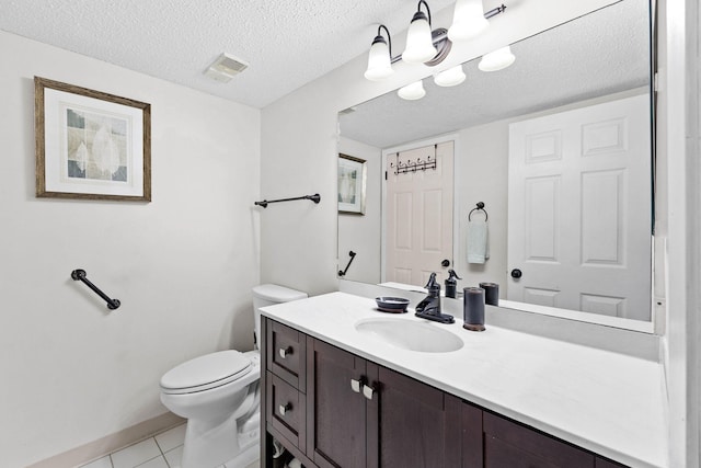 bathroom with visible vents, toilet, a textured ceiling, tile patterned flooring, and vanity